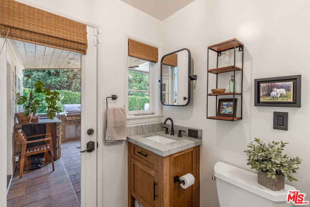 875 Hugo Reid Drive Arcadia, CA 91007 - Photo 26 of 53 a bathroom with a granite countertop sink and a mirror