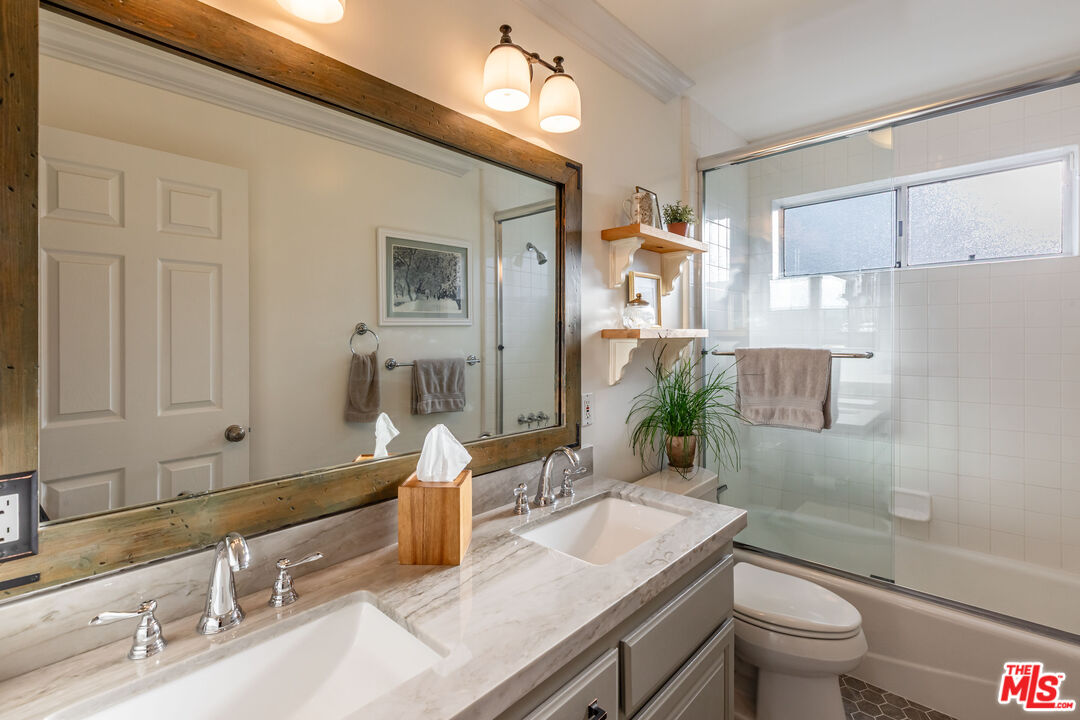 875 Hugo Reid Drive Arcadia, CA 91007 - Photo 28 of 53 a bathroom with a granite countertop sink a toilet and mirror