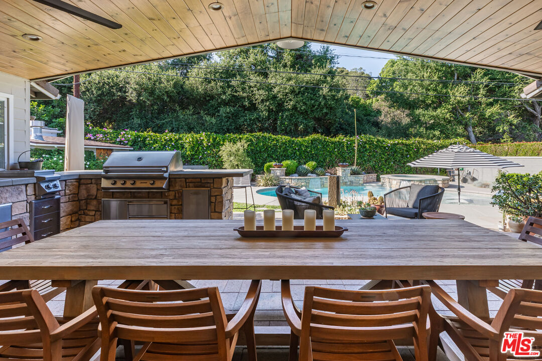 875 Hugo Reid Drive Arcadia, CA 91007 - Photo 33 of 53 a view of a patio with table and chairs a barbeque with wooden floor and roof
