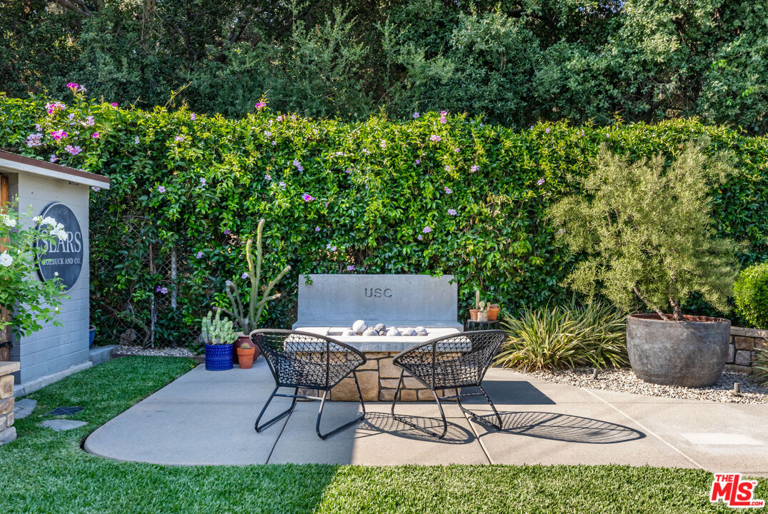 875 Hugo Reid Drive Arcadia, CA 91007 - Photo 40 of 53 a view of a backyard with table and chairs and potted plants