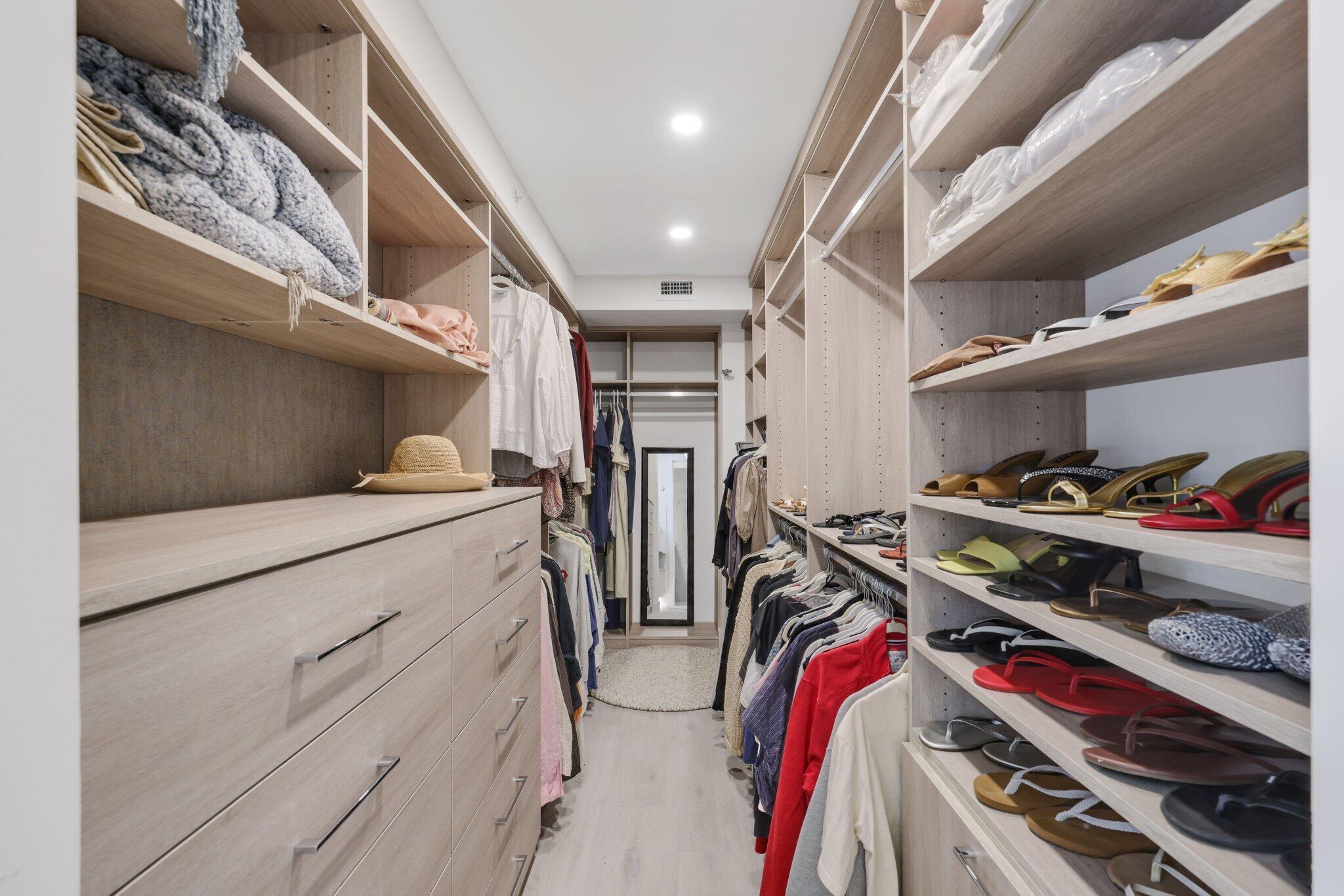 100 Southeast 5th Avenue, Unit 106 Boca Raton, FL 33432 - Photo 30 of 81 a view of walk in closet with clothes and shoes