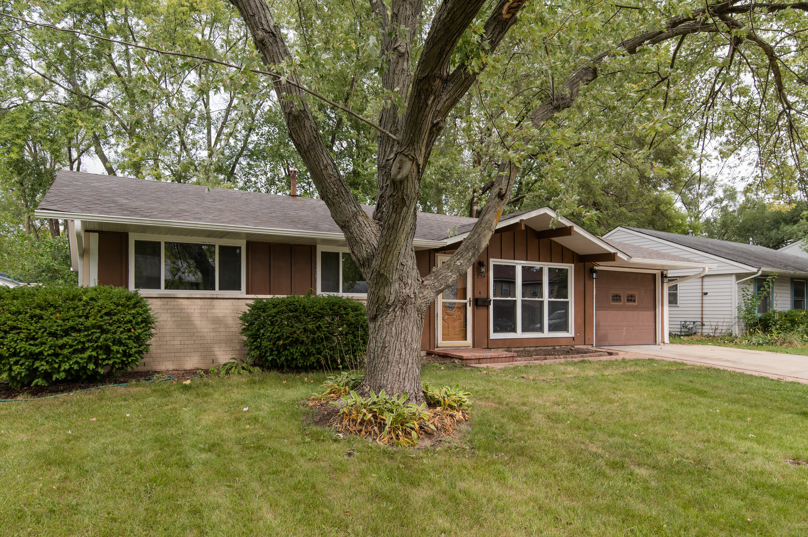 734 Surrey Drive Streamwood, IL 60107 - Photo 2 of 36 a front view of a house with a garden