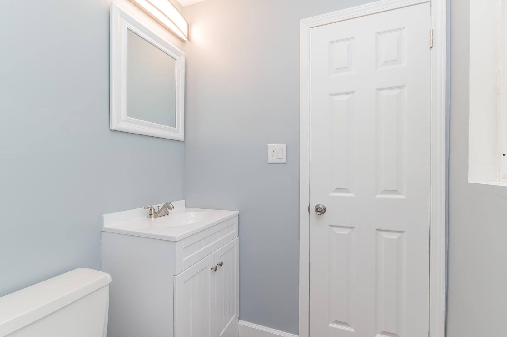 734 Surrey Drive Streamwood, IL 60107 - Photo 17 of 36 a bathroom with a sink a toilet and a mirror