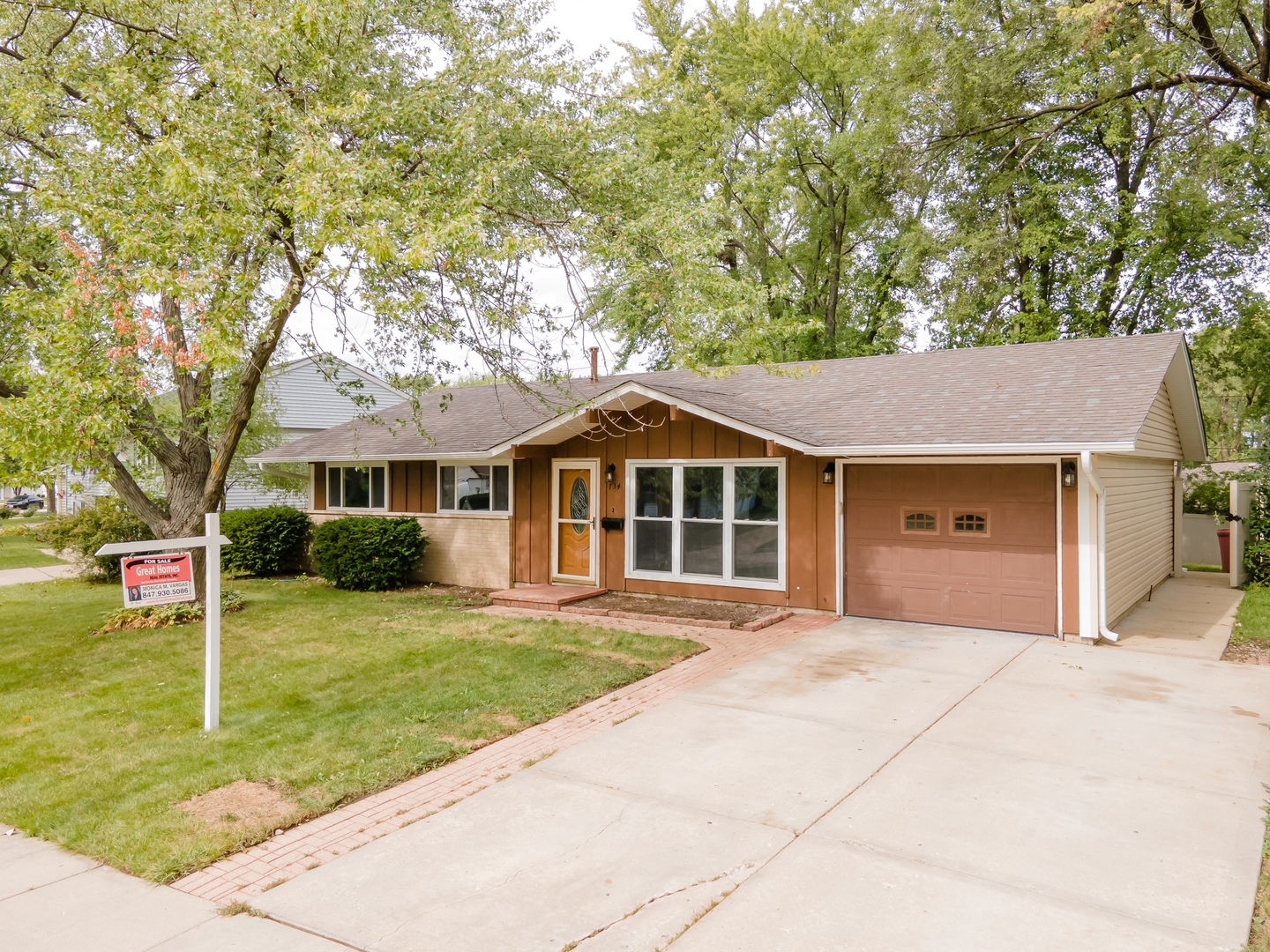 734 Surrey Drive Streamwood, IL 60107 - Photo 3 of 36 a front view of a house with a yard and trees