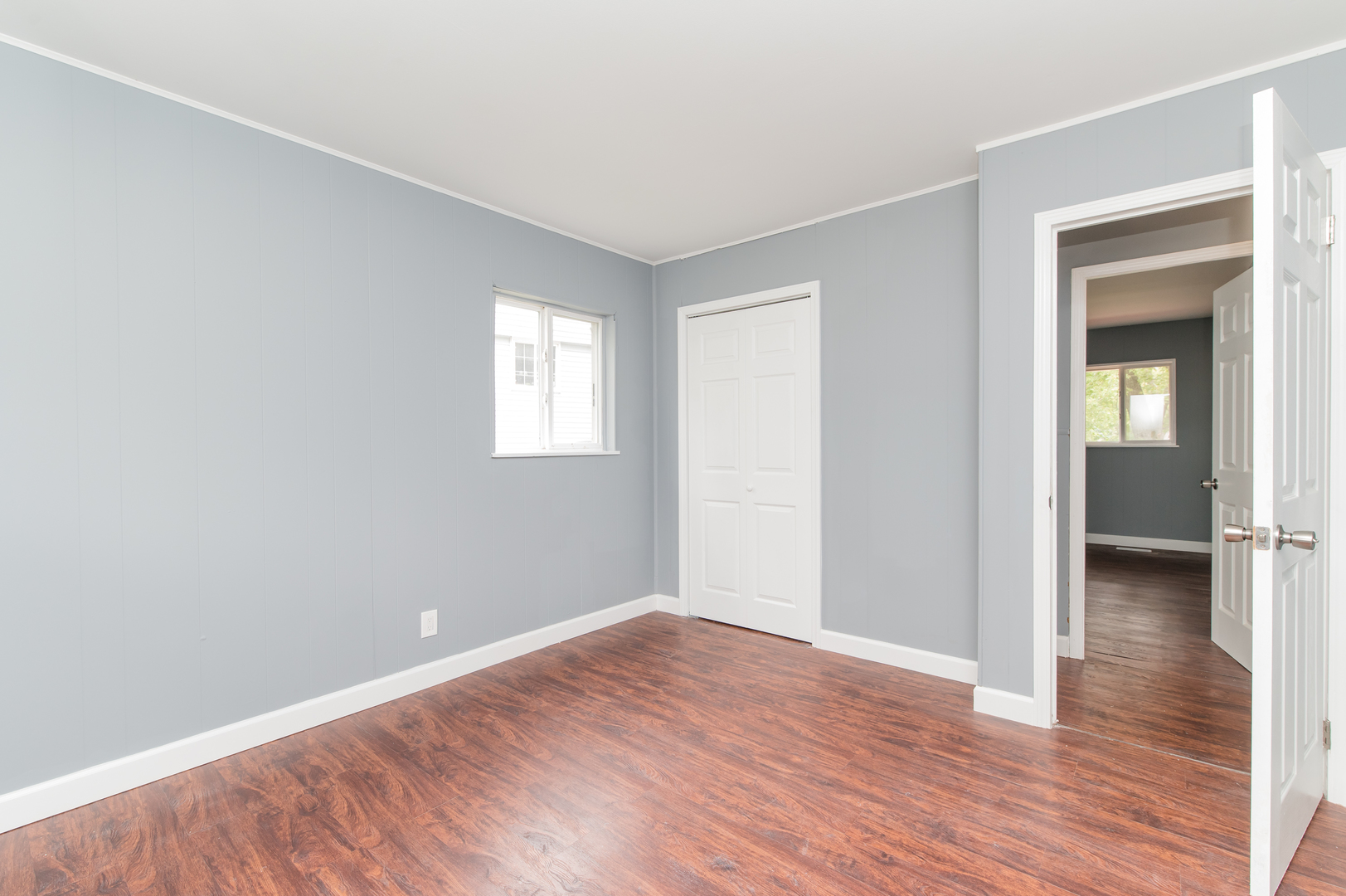 734 Surrey Drive Streamwood, IL 60107 - Photo 21 of 36 a view of an empty room with wooden floor and a window