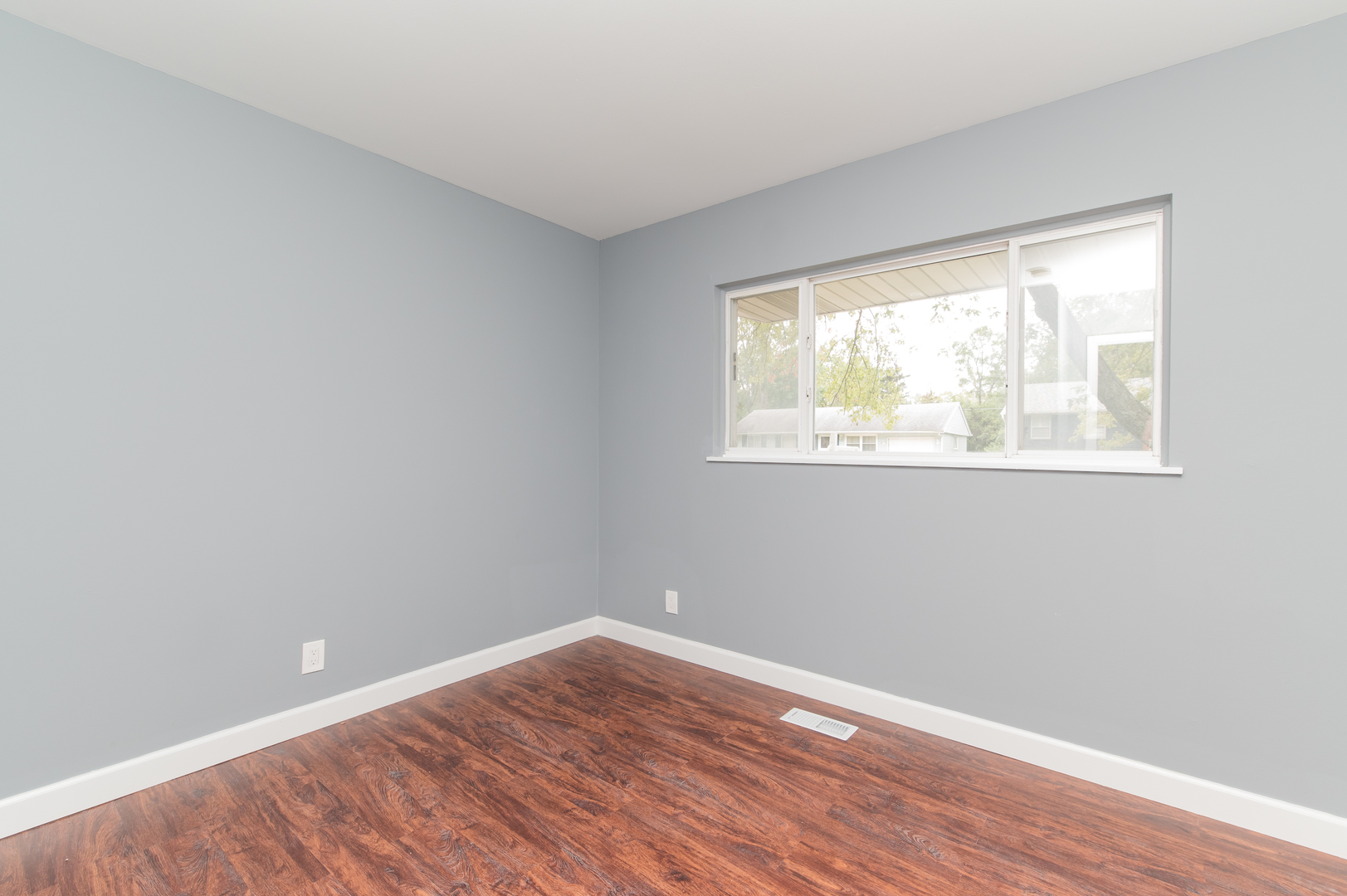 734 Surrey Drive Streamwood, IL 60107 - Photo 22 of 36 a view of an empty room with wooden floor and a window