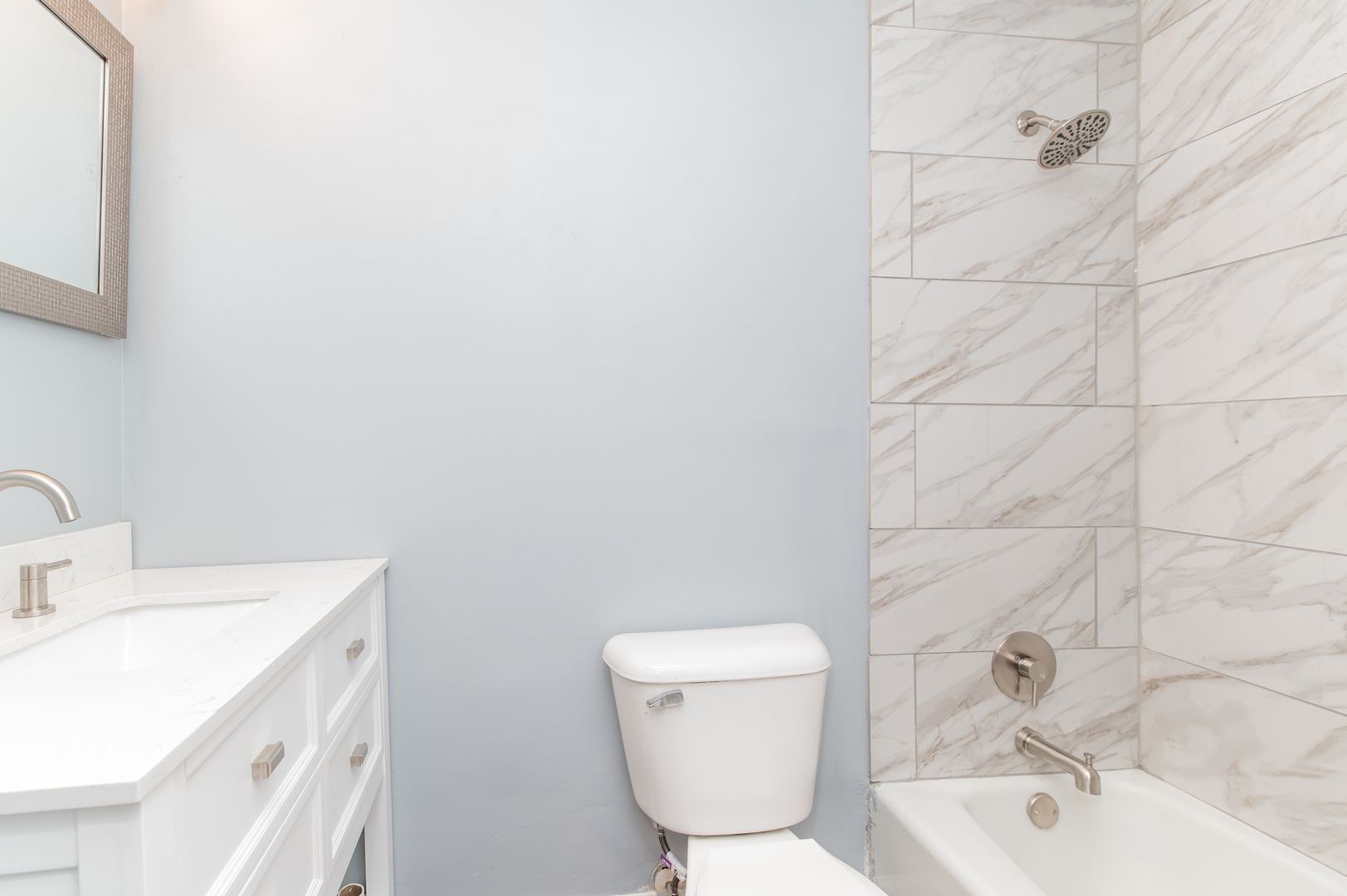 734 Surrey Drive Streamwood, IL 60107 - Photo 24 of 36 a bathroom with a sink a toilet and mirror