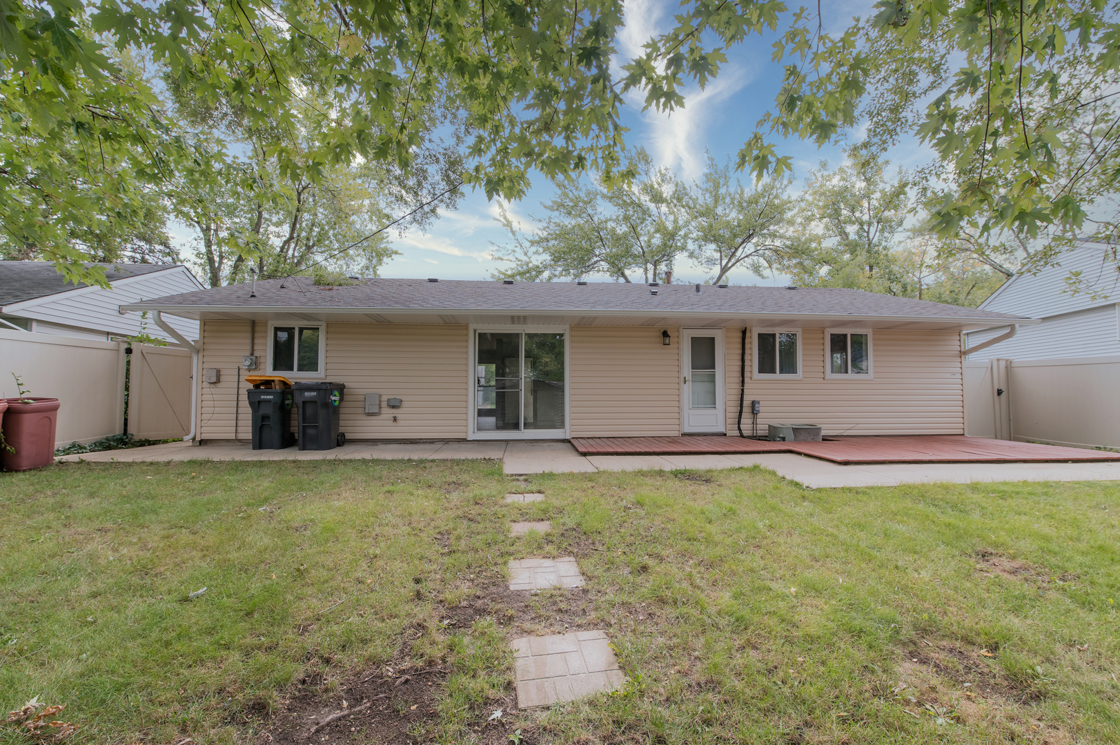 734 Surrey Drive Streamwood, IL 60107 - Photo 32 of 36 a front view of a house with a garden and trees