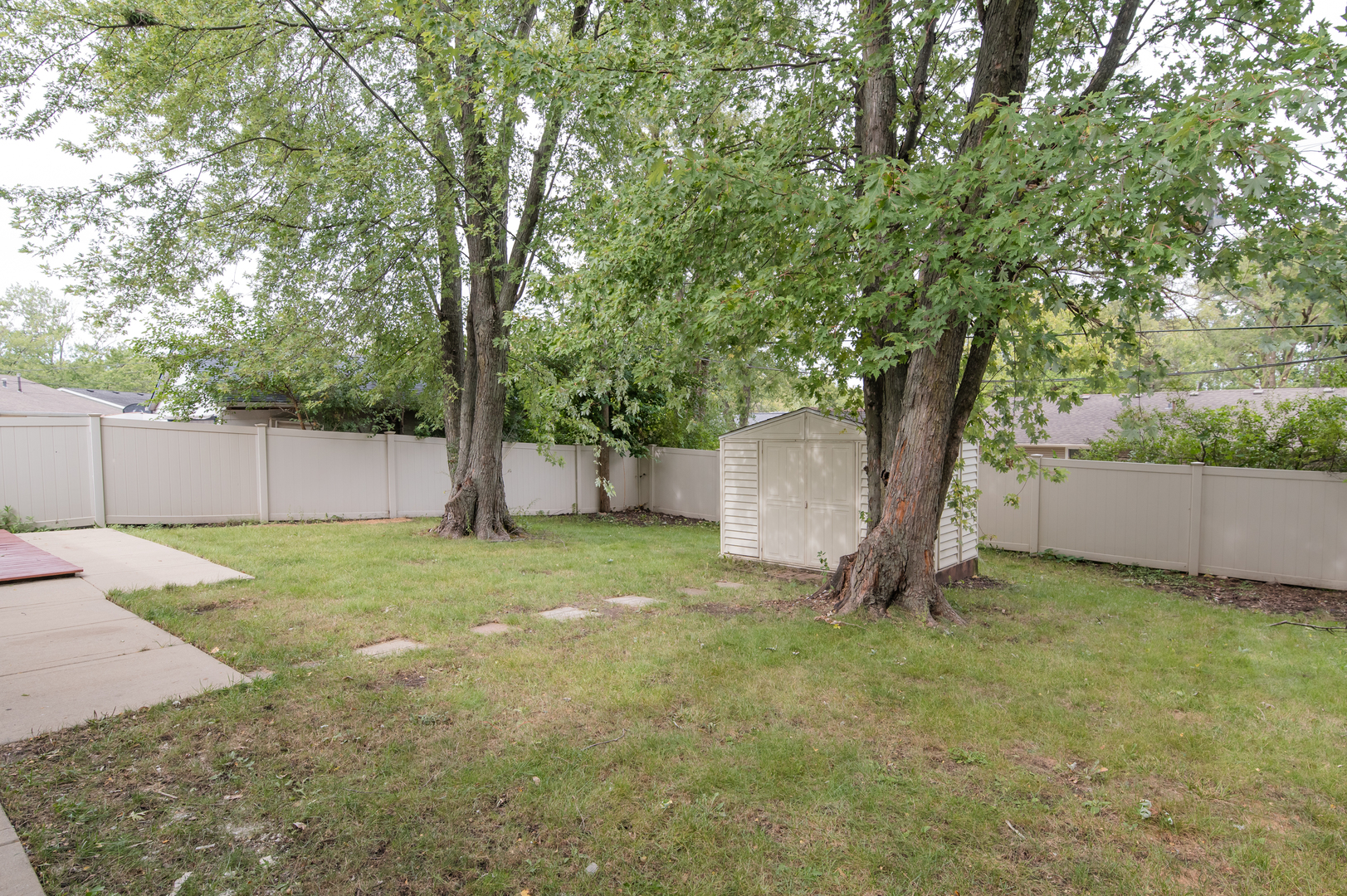 734 Surrey Drive Streamwood, IL 60107 - Photo 33 of 36 a view of a backyard with large tree and a large tree