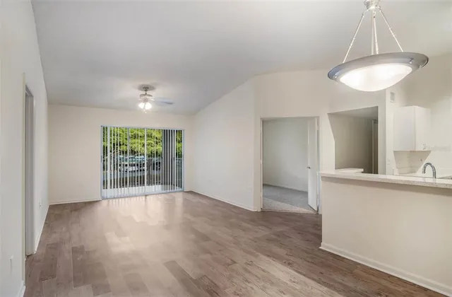 an empty room with wooden floor and a window