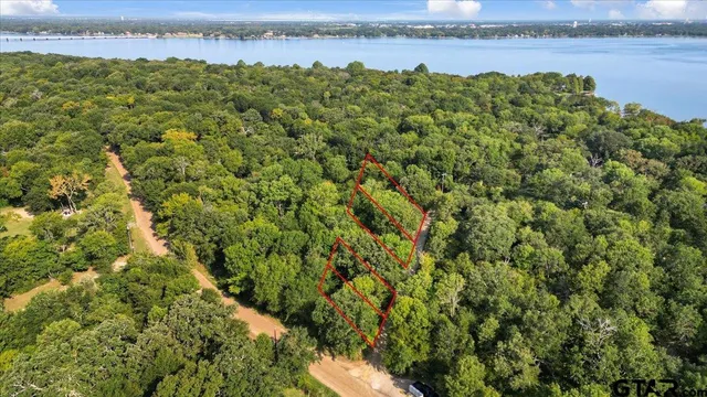 a view of a lake with houses in the back