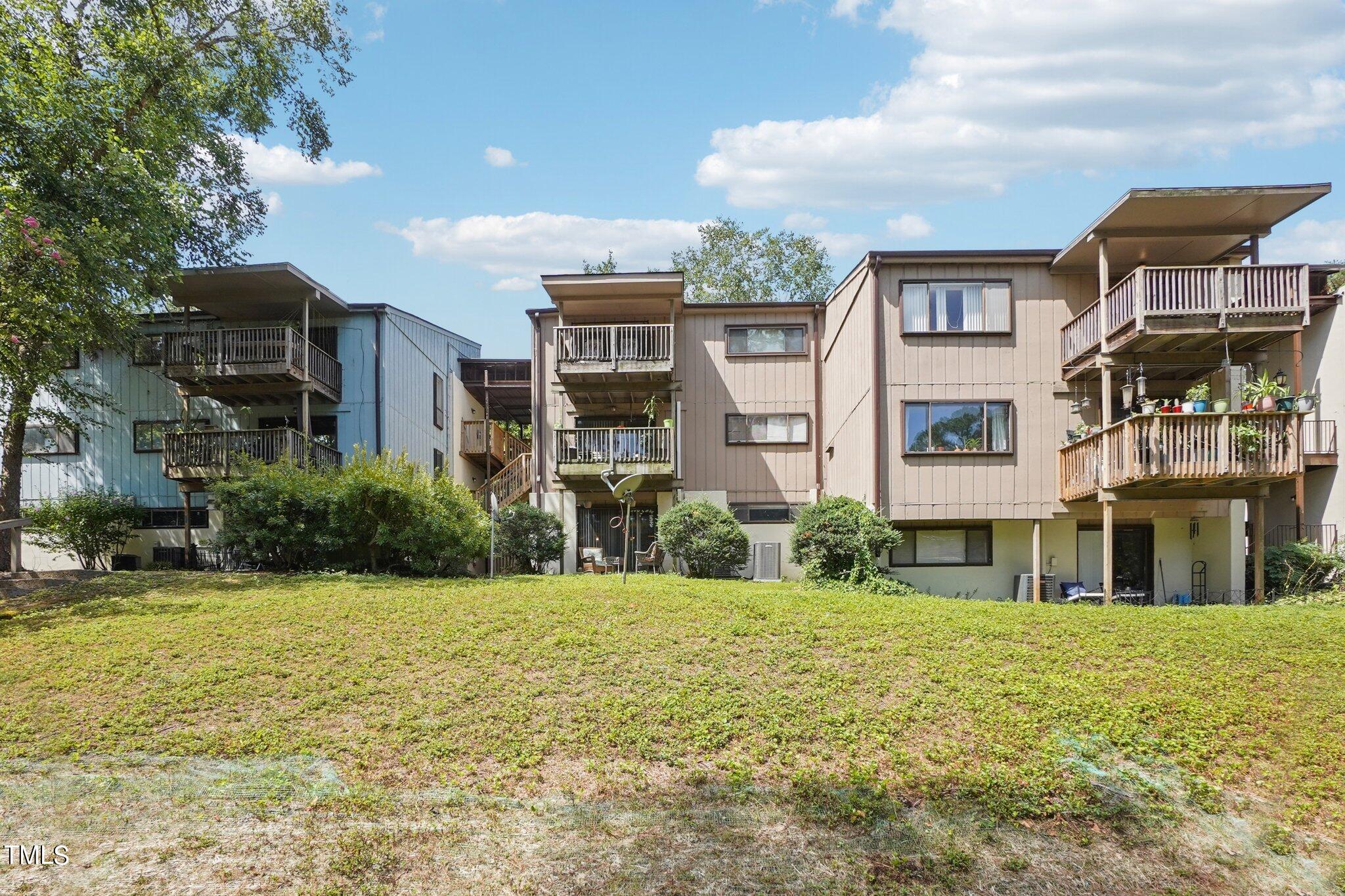 5104 Flint Ridge Place Raleigh, NC 27609 - Photo 1 of 16 a front view of a residential apartment building with a yard