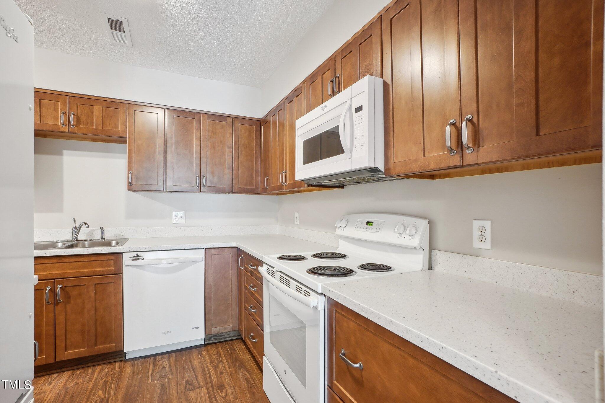 5104 Flint Ridge Place Raleigh, NC 27609 - Photo 3 of 16 a kitchen with a sink a stove and cabinets