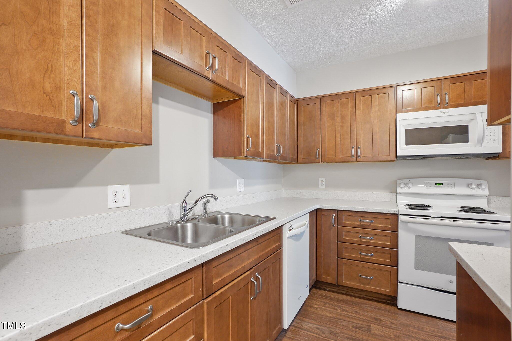 5104 Flint Ridge Place Raleigh, NC 27609 - Photo 4 of 16 a kitchen with a sink and cabinets