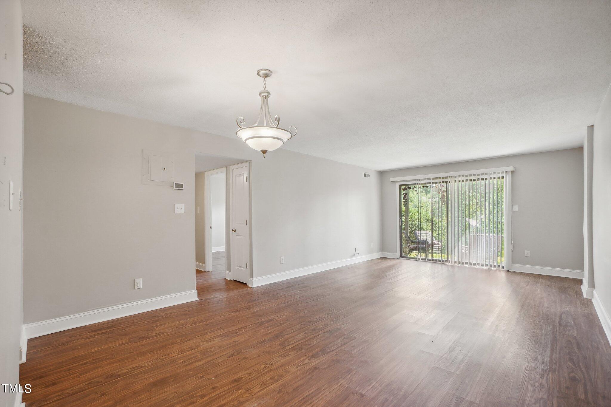 5104 Flint Ridge Place Raleigh, NC 27609 - Photo 6 of 16 a view of empty room with wooden floor and window