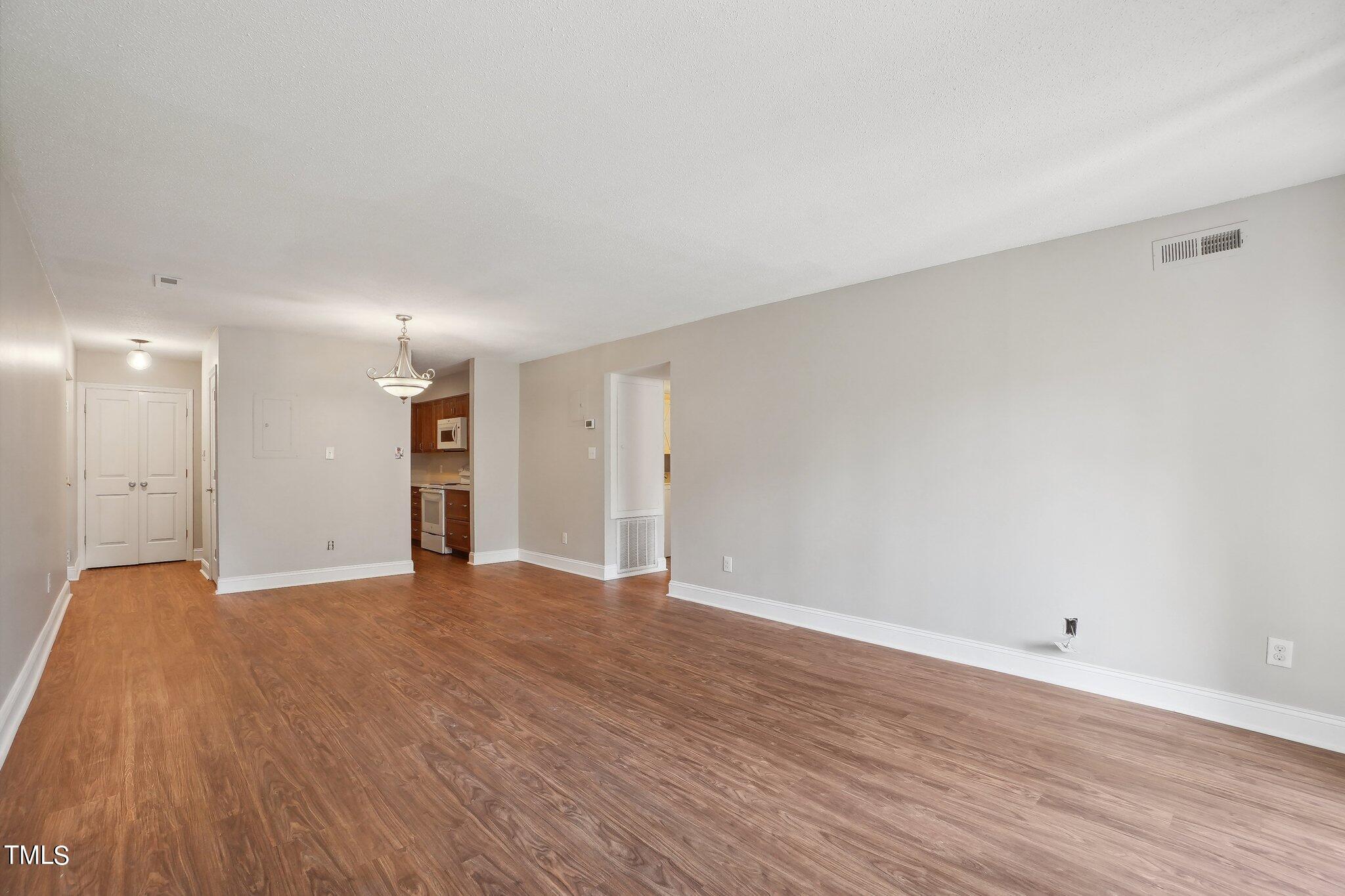 5104 Flint Ridge Place Raleigh, NC 27609 - Photo 8 of 16 a view of an empty room with wooden floor