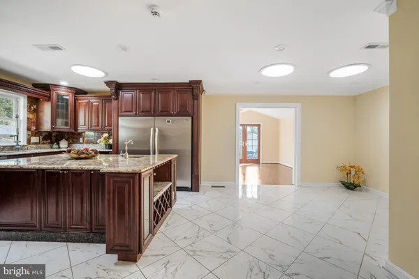 a kitchen with stainless steel appliances granite countertop a sink stove and cabinets