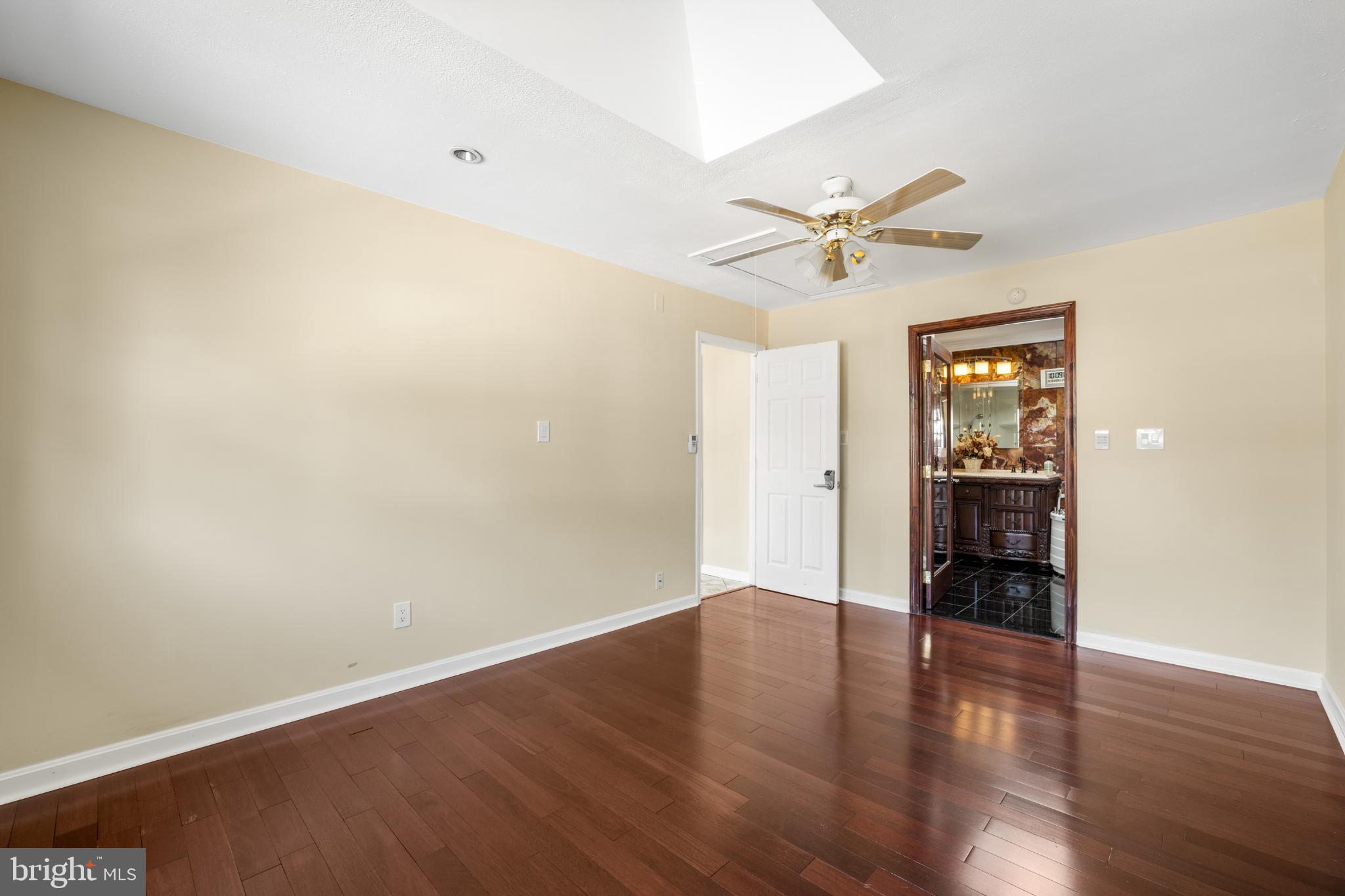 4104 Tulare Drive Silver Spring, MD 20906 - Photo 16 of 44 an empty room with wooden floor and a ceiling fan