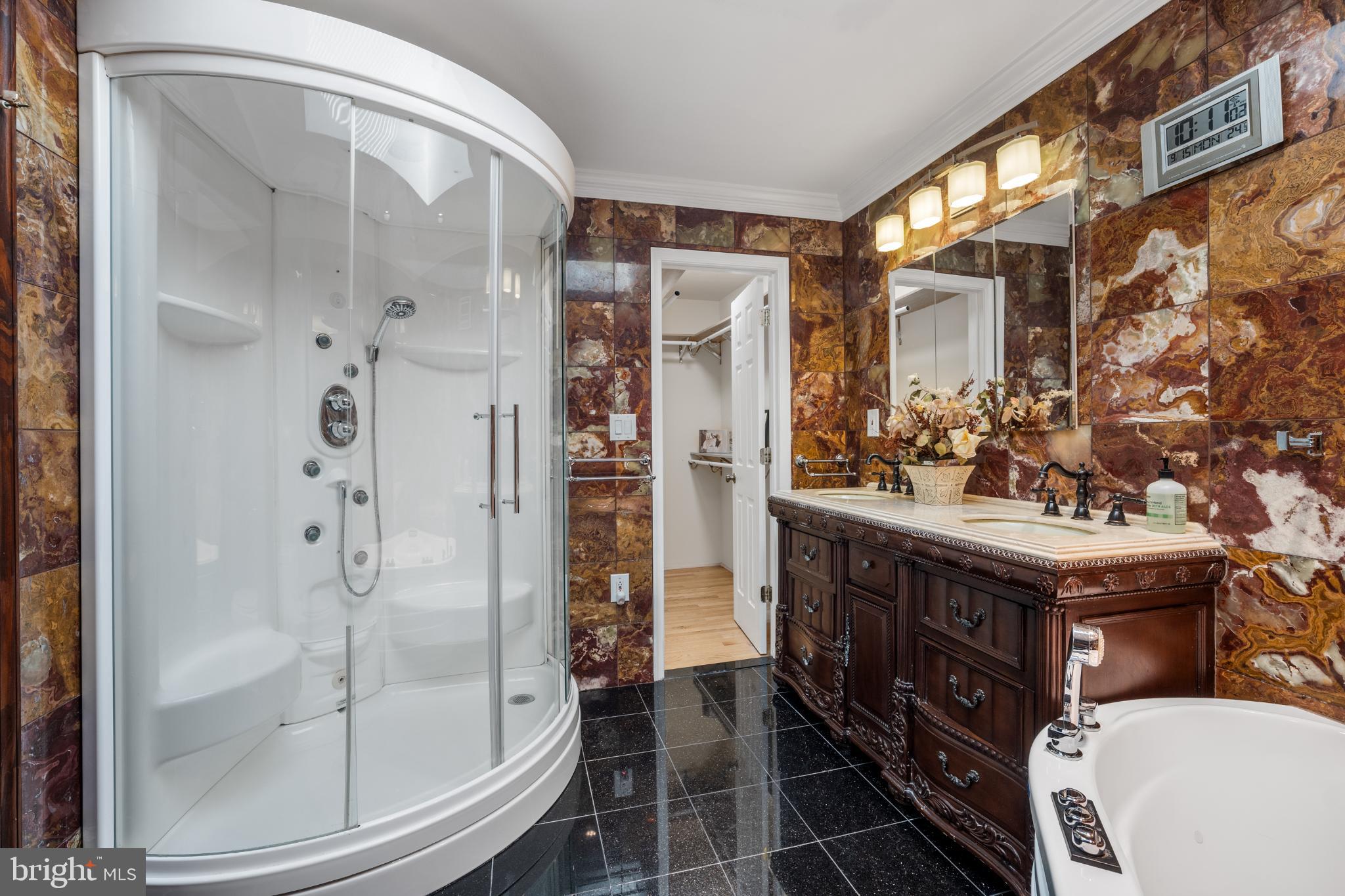 4104 Tulare Drive Silver Spring, MD 20906 - Photo 20 of 44 a bathroom with a granite countertop shower a sink and a mirror