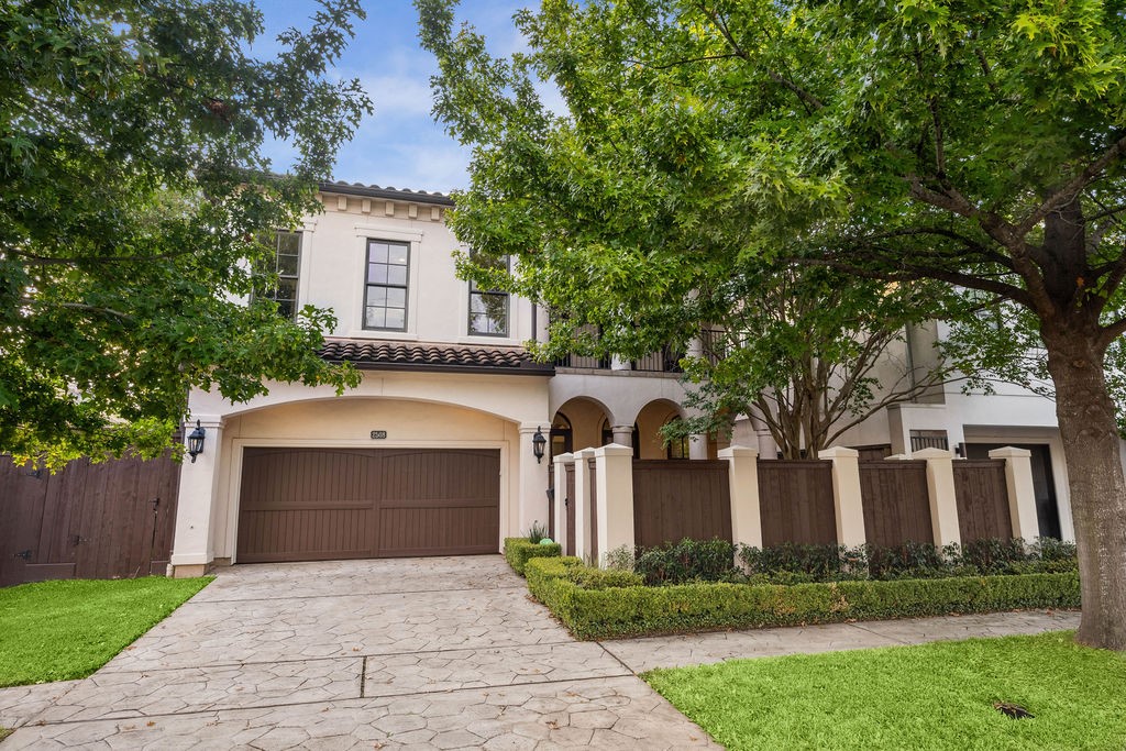 2508 Brun Street Houston, TX 77019 - Photo 1 of 50 This charming two-story home features a Mediterranean-style exterior with a tiled roof, a spacious two-car garage, and an inviting front courtyard. The lush landscaping and mature trees add to its curb appeal, creating a welcoming and serene atmosphere.