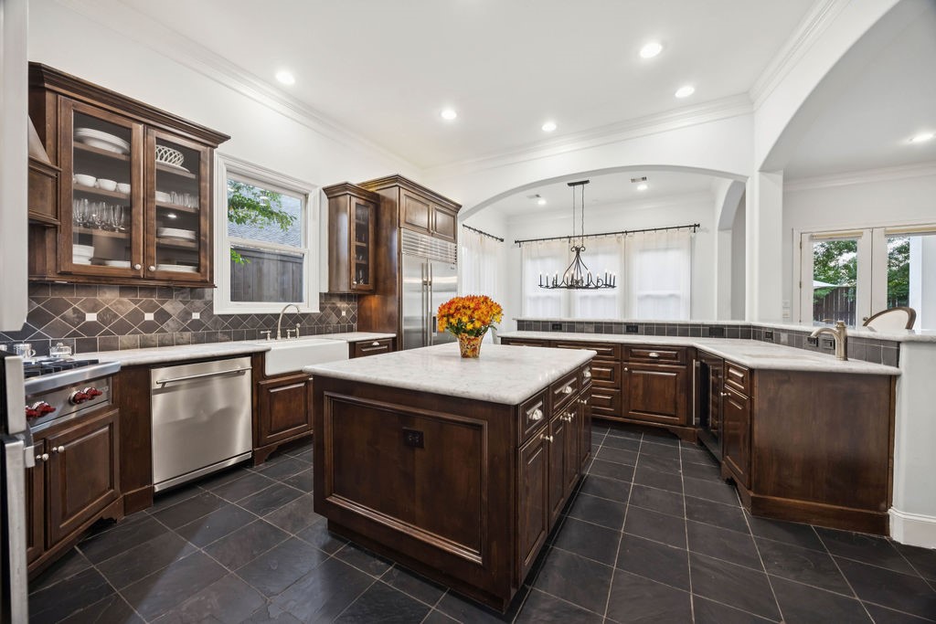 2508 Brun Street Houston, TX 77019 - Photo 19 of 50 Another view of this gorgeous kitchen. The open layout includes ample natural light and a stylish dining area with a chandelier.