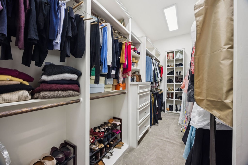 2508 Brun Street Houston, TX 77019 - Photo 37 of 50 This photo showcases a spacious, well-organized walk-in closet with ample shelving, hanging space, and storage for clothing and shoes. The room is brightly lit with a modern design, offering a luxurious and functional addition to the home.