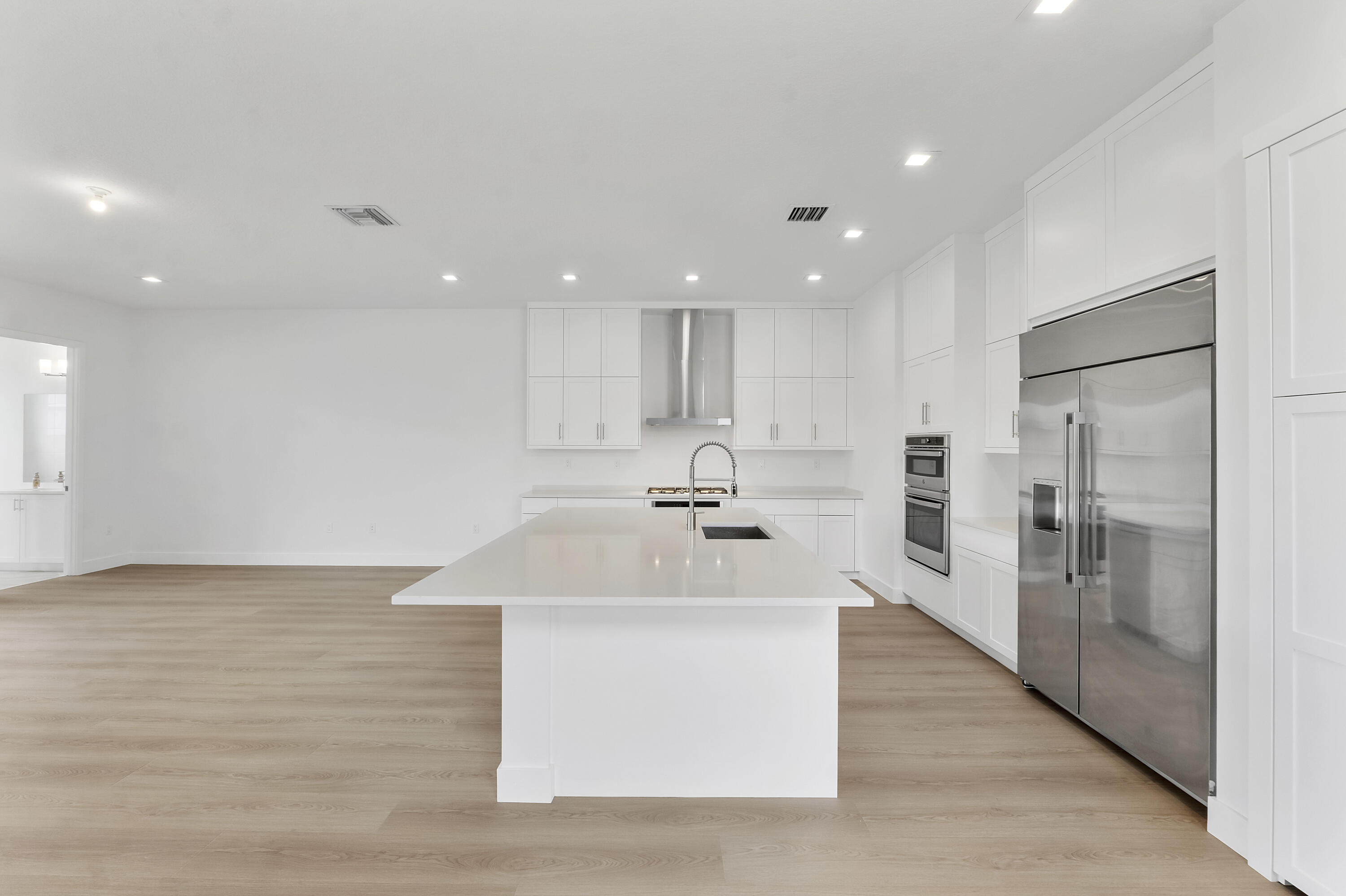 9322 Sunflower Mdw Road Boca Raton, FL 33434 - Photo 8 of 87 a large white kitchen with a sink and a large window