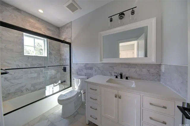 a bathroom with a sink toilet and shower