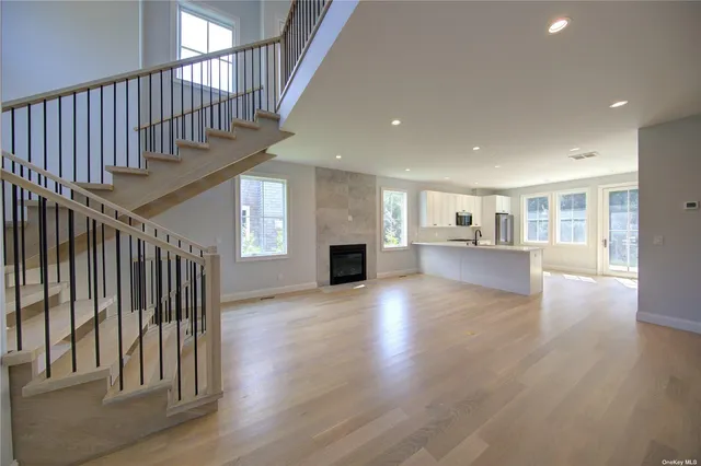 a view of staircase with wooden floor and a kitchen