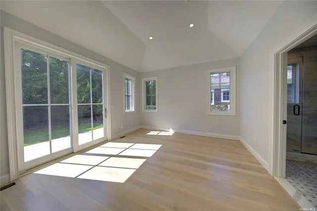 a view of an empty room with glass door