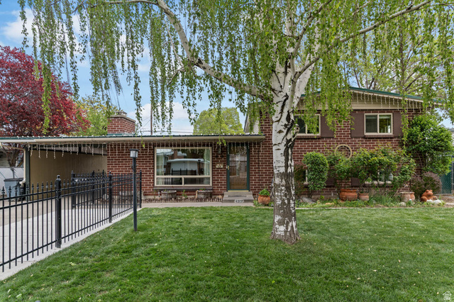4317 Bennion Road Taylorsville, UT 84129 - Photo 1 of 1 Rear view of house featuring a chimney and brick siding