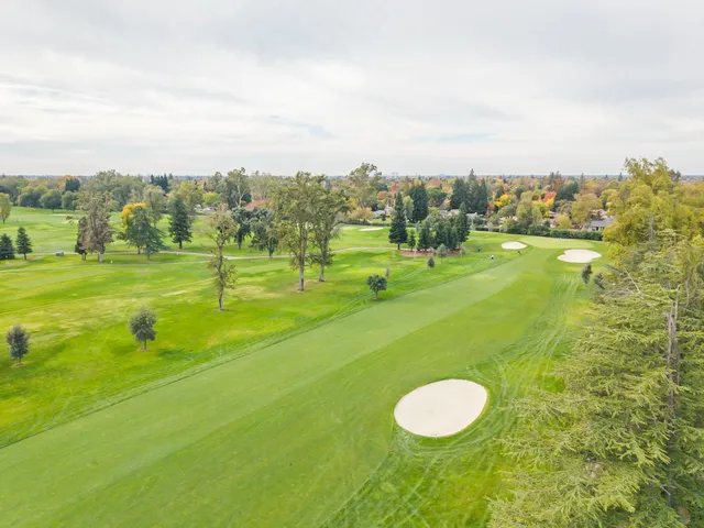 a view of a golf course with a lake view