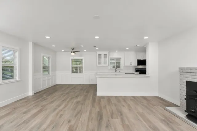 a view of kitchen with kitchen island granite countertop stainless steel appliances refrigerator sink and microwave