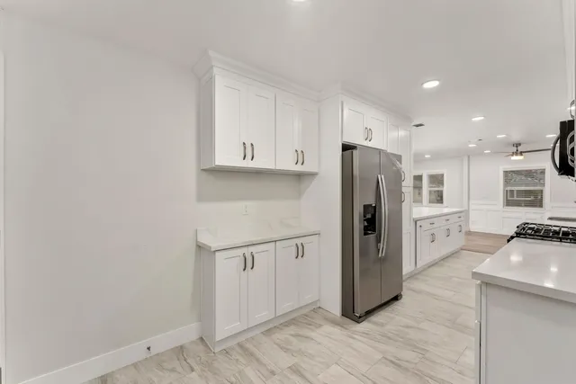 a kitchen with stainless steel appliances a refrigerator sink and stove