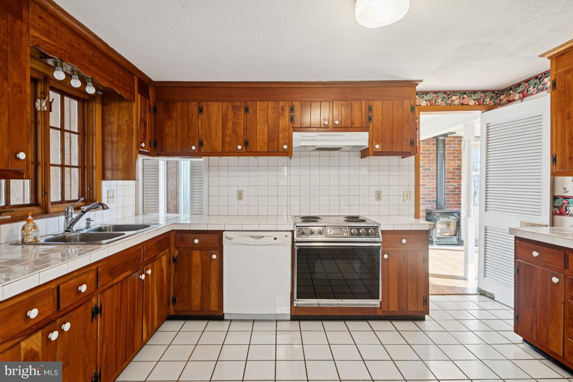 2701 Carrollton Road Finksburg, MD 21048 - Photo 28 of 66 a kitchen with stainless steel appliances granite countertop a stove a sink dishwasher and a refrigerator