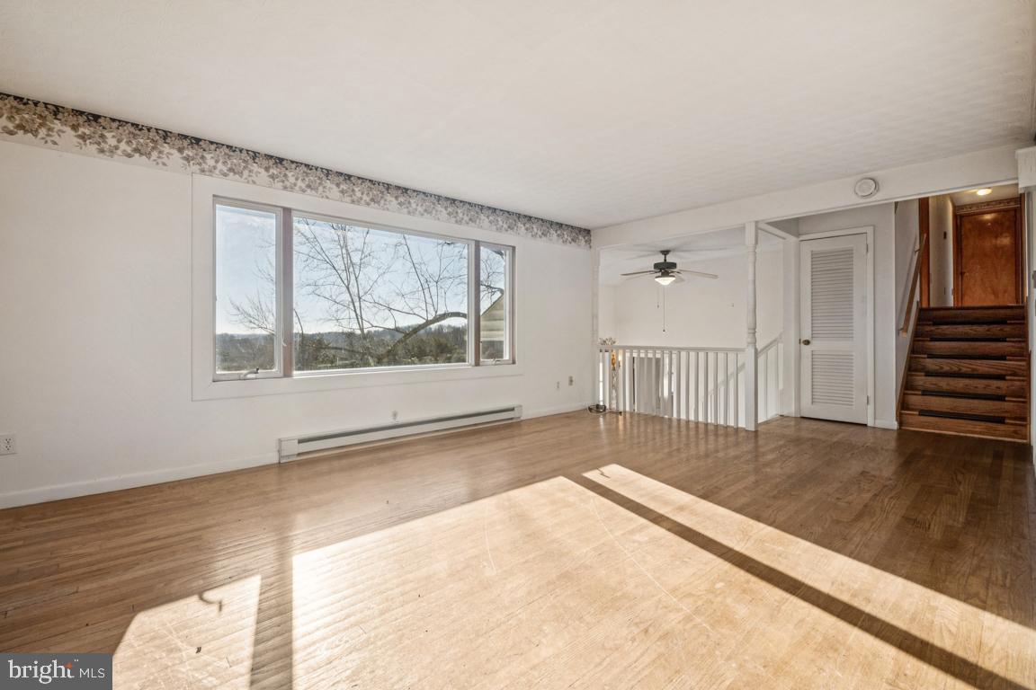 2701 Carrollton Road Finksburg, MD 21048 - Photo 31 of 66 a view of empty room with wooden floor and fan
