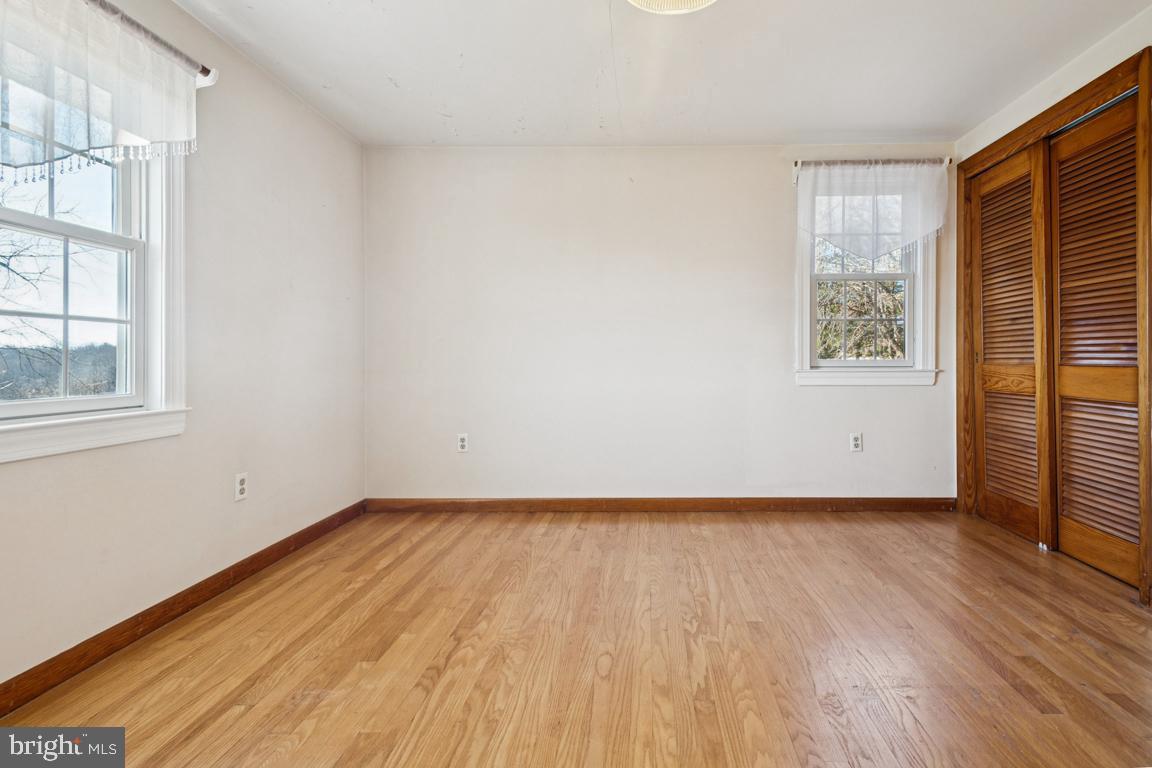 2701 Carrollton Road Finksburg, MD 21048 - Photo 43 of 66 a view of an empty room with wooden floor and a window