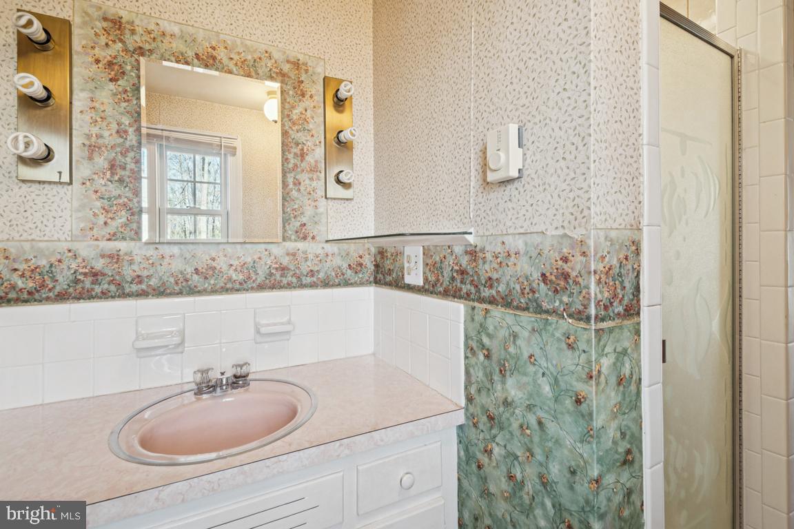 2701 Carrollton Road Finksburg, MD 21048 - Photo 50 of 66 a bathroom with a granite countertop sink a mirror and shower