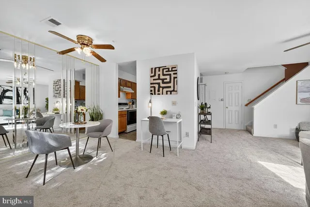 a view of a livingroom with furniture and table in a room