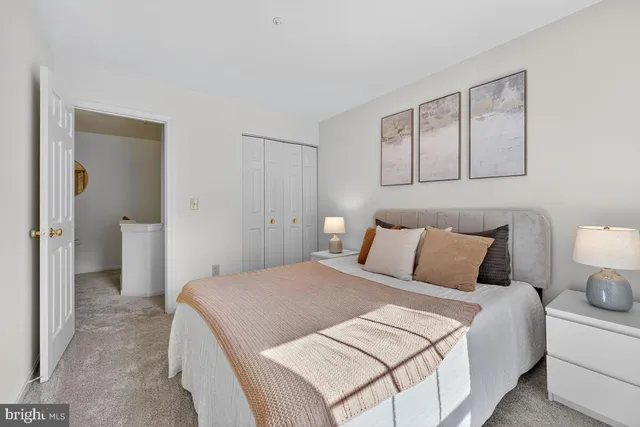 a bedroom with a bed and a lamp