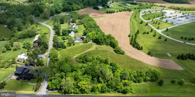 an aerial view of a house with a yard and plants