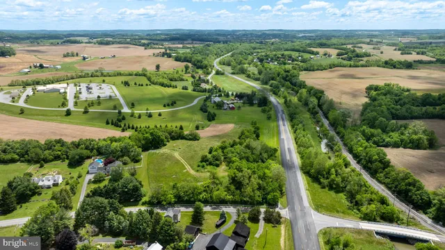 an aerial view of residential houses with outdoor space and river