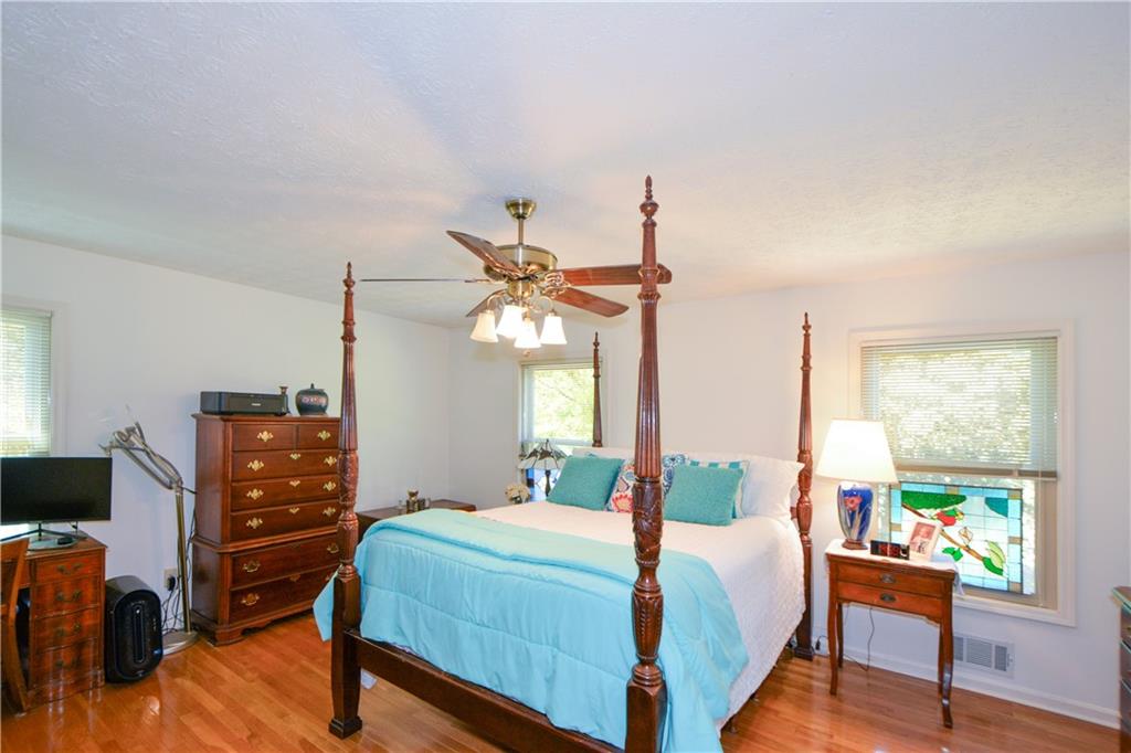 130 Hawn Road Fayetteville, GA 30215 - Photo 17 of 67 a bedroom with a bed and a dresser next to a window