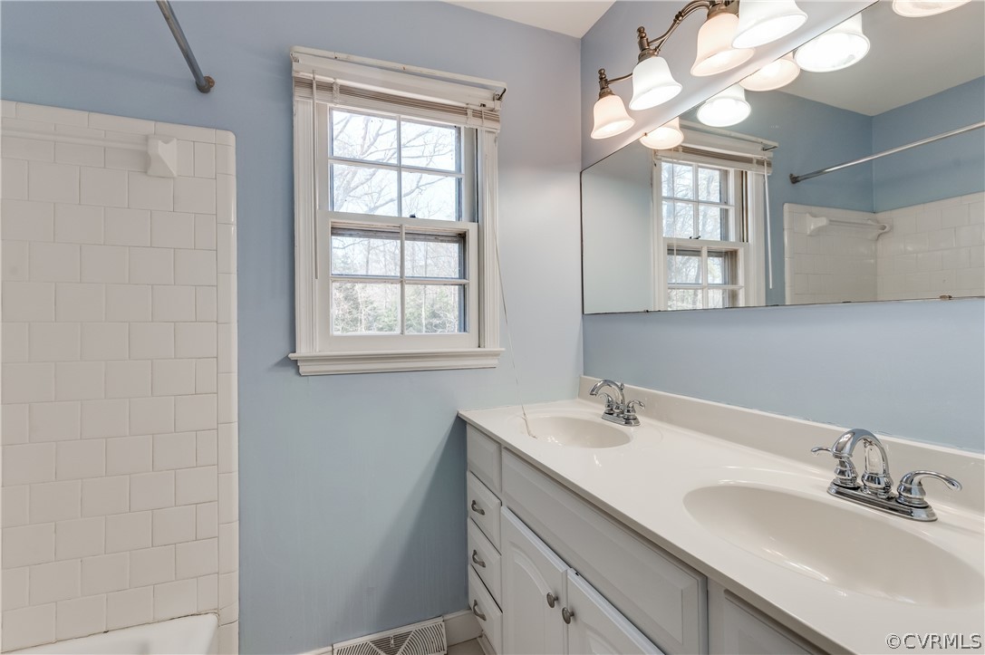 11000 Chalkley Road Chester, VA 23831 - Photo 21 of 30 a bathroom with a sink a vanity and a mirror