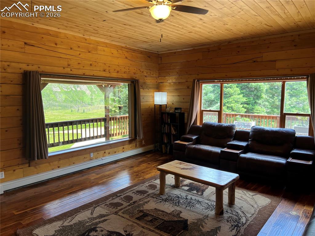 87 Thompson Road Gardner, CO 81040 - Photo 12 of 46 a living room with furniture and a floor to ceiling window