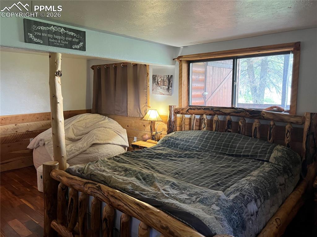 87 Thompson Road Gardner, CO 81040 - Photo 27 of 46 a bedroom with a bed and wooden floor