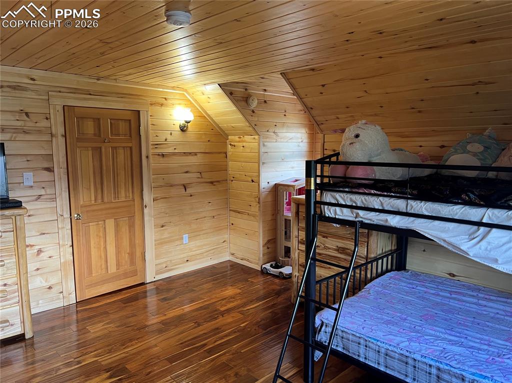 87 Thompson Road Gardner, CO 81040 - Photo 31 of 46 an empty room with wooden floor and windows