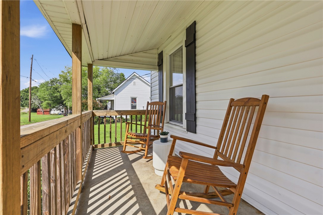 1 Brock Street Pelzer, SC 29669 - Photo 2 of 25 Relax on the charming covered front porch, enjoying views of the tranquil neighborhood.