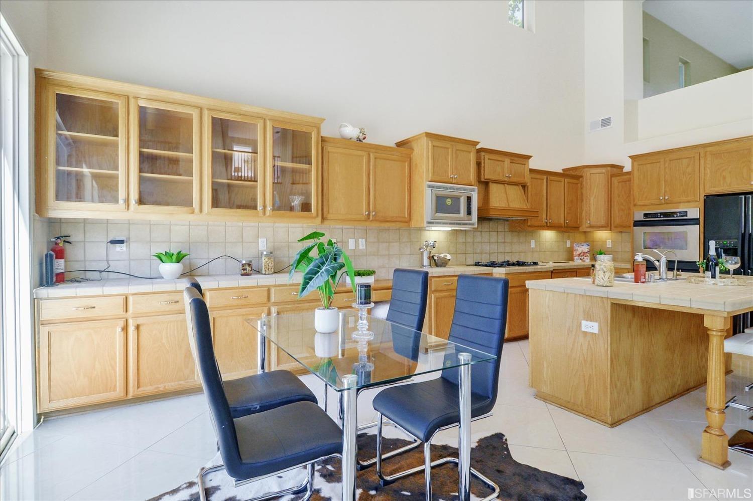 4100 Diorite Court Antioch, CA 94531 - Photo 11 of 58 a kitchen with a table chairs stove and cabinets