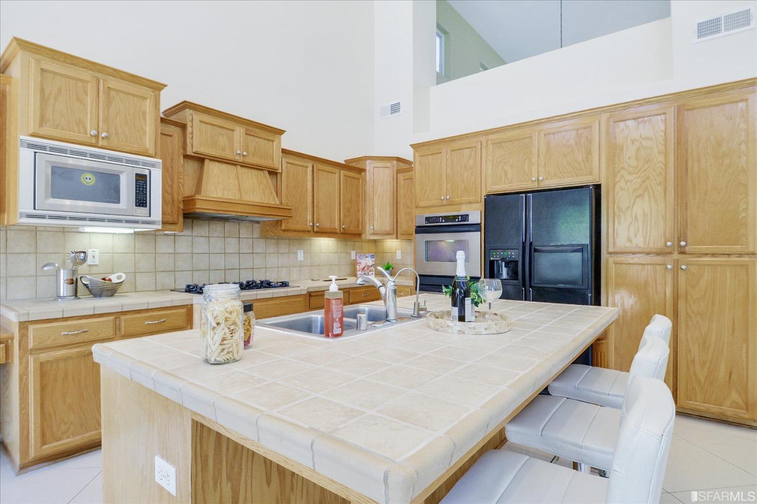 4100 Diorite Court Antioch, CA 94531 - Photo 14 of 58 a kitchen with stainless steel appliances a sink a table and chairs